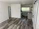 Open-concept living area with updated flooring and a view of the modern kitchen at 2815 S Dexter Way, Denver, CO 80222