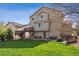 Spacious green backyard featuring a deck, patio with seating, and stairs leading to a lower-level entrance at 3978 Aspen Hollow Ct, Castle Rock, CO 80104
