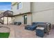 Backyard patio area with cozy seating, a built-in fire pit, and a beautiful paver patio adjacent to the house at 3978 Aspen Hollow Ct, Castle Rock, CO 80104