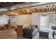 Spacious basement area with exposed ceiling, walkout access, bar seating, and comfortable lounge furniture at 3978 Aspen Hollow Ct, Castle Rock, CO 80104
