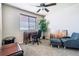 Cozy bedroom with a ceiling fan, a desk with a rolling chair, a plant, an accent armchair, and carpeted floors at 3978 Aspen Hollow Ct, Castle Rock, CO 80104