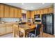 Well-appointed kitchen with wooden cabinets, black appliances, and an efficient layout at 3978 Aspen Hollow Ct, Castle Rock, CO 80104