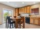 Eat-in kitchen with wooden cabinetry, black appliances, and ample counter space at 3978 Aspen Hollow Ct, Castle Rock, CO 80104