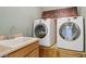 Modern laundry room featuring new Samsung washer and dryer units with a sink and countertop at 3978 Aspen Hollow Ct, Castle Rock, CO 80104