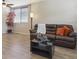 Open-concept living area with wood floors, a comfy sofa, and decorative accents at 3978 Aspen Hollow Ct, Castle Rock, CO 80104