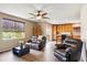 Open-concept living room with wood floors, natural light, and kitchen view at 3978 Aspen Hollow Ct, Castle Rock, CO 80104