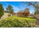 Spacious backyard featuring a well-maintained lawn and covered patio, ideal for outdoor gatherings at 19061 E Powers Pl, Aurora, CO 80015