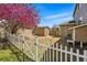 Fenced backyard featuring a storage shed, mature trees, and gravel area at 19061 E Powers Pl, Aurora, CO 80015