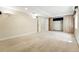 Finished basement area with built-in shelving and neutral colored carpeting at 19061 E Powers Pl, Aurora, CO 80015