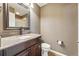 Bathroom featuring a granite countertop, dark vanity, and modern fixtures at 19061 E Powers Pl, Aurora, CO 80015
