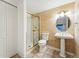 Downstairs bathroom featuring decorative walls, pedestal sink, and glass shower at 19061 E Powers Pl, Aurora, CO 80015