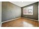 Bedroom featuring wood floors, neutral paint, a large window and ample space at 19061 E Powers Pl, Aurora, CO 80015