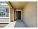 Inviting front entrance with a black door and stylish exterior lighting at 19061 E Powers Pl, Aurora, CO 80015