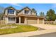 Attractive two-story home with a spacious three-car garage and green lawn at 19061 E Powers Pl, Aurora, CO 80015