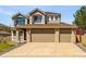 Beautiful two-story home with a three-car garage and manicured front yard at 19061 E Powers Pl, Aurora, CO 80015