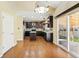 Eat-in kitchen with dark cabinets, granite countertops, island, and access to the patio at 19061 E Powers Pl, Aurora, CO 80015