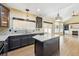Kitchen featuring granite countertops, stainless steel appliances, and kitchen island overlooking fireplace at 19061 E Powers Pl, Aurora, CO 80015