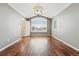 Bright living room featuring beautiful hardwood floors and a large window with neighborhood views at 19061 E Powers Pl, Aurora, CO 80015