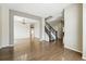 Open-concept living area with hardwood floors and staircase at 19061 E Powers Pl, Aurora, CO 80015
