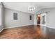 This is a spacious living area with warm wood floors and access to the bathroom at 19061 E Powers Pl, Aurora, CO 80015