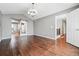 Spacious living area with warm wood floors, access to the upper level, and a sliding barn door at 19061 E Powers Pl, Aurora, CO 80015