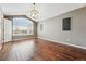 Bright living room featuring beautiful hardwood floors and a large arched window at 19061 E Powers Pl, Aurora, CO 80015