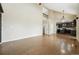 Bright living room featuring hardwood floors and tall ceilings, leading to an open kitchen at 19061 E Powers Pl, Aurora, CO 80015