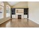 Spacious living room featuring a stone fireplace and built-in shelving at 19061 E Powers Pl, Aurora, CO 80015