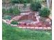 Delightful garden with vibrant flowers and a charming waterfall feature at 5519 Fullerton Cir, Highlands Ranch, CO 80130