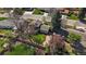 A well-landscaped backyard with patio, surrounded by mature trees and a fence at 12155 W 68Th Pl, Arvada, CO 80004