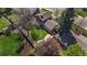 Aerial shot of a private backyard with a stone patio, mature trees, lush green lawn and perimeter fencing at 12155 W 68Th Pl, Arvada, CO 80004