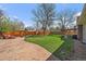 A beautiful backyard with a well-maintained lawn, patio, lounge set, and pergola for outdoor entertaining at 12155 W 68Th Pl, Arvada, CO 80004