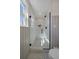 Bright bathroom featuring white subway tile, black hardware, and glass-enclosed shower at 12155 W 68Th Pl, Arvada, CO 80004