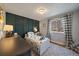 bedroom with patterned accent wall, natural light, and geometric carpet at 12155 W 68Th Pl, Arvada, CO 80004