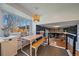 Eat in breakfast nook with large window and bench style seating in a naturally lit room at 12155 W 68Th Pl, Arvada, CO 80004