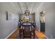 Elegant dining room featuring hardwood floors, a stylish chandelier, and large windows for natural light at 12155 W 68Th Pl, Arvada, CO 80004