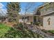 Inviting front entrance with a charming walkway and colorful landscaping, showcasing the home's curb appeal at 12155 W 68Th Pl, Arvada, CO 80004
