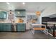 Modern kitchen with stylish blue cabinets, stainless steel appliances, and a cozy breakfast nook at 12155 W 68Th Pl, Arvada, CO 80004