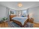 Bright main bedroom with hardwood floors, large windows, and a colorful rug at 12155 W 68Th Pl, Arvada, CO 80004