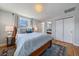 Spacious main bedroom with hardwood floors, natural light, and closet storage at 12155 W 68Th Pl, Arvada, CO 80004