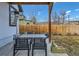 This shaded patio features a dining table, a patio heater, and backyard access at 2572 Chase St, Edgewater, CO 80214