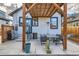 A covered patio area with outdoor dining table, grill and a back entry to the home at 2572 Chase St, Edgewater, CO 80214