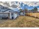 Large backyard with a lawn, storage shed, fencing, and a patio with seating at 2572 Chase St, Edgewater, CO 80214