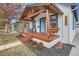 Charming home featuring a cozy front porch with wooden beams and a porch swing at 2572 Chase St, Edgewater, CO 80214