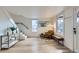 Bright living room with hardwood floors, staircase, and an abundance of natural light at 2572 Chase St, Edgewater, CO 80214