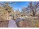 Landscaped backyard featuring stone walkway and pergola, offering a serene outdoor space at 5442 S Cedar St, Littleton, CO 80120