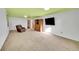 Basement featuring vintage cabinet with TV and carpeted floors, comfortable chair at 5442 S Cedar St, Littleton, CO 80120