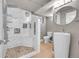 Modern bathroom featuring a stand up shower with stone floor, tile surround, and a unique sink at 5442 S Cedar St, Littleton, CO 80120