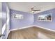 Bedroom with two windows, ceiling fan, hard wood floors and freshly painted walls at 5442 S Cedar St, Littleton, CO 80120