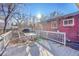 Outdoor deck, perfect for relaxation or entertaining featuring a dining table and a gas grill at 5442 S Cedar St, Littleton, CO 80120